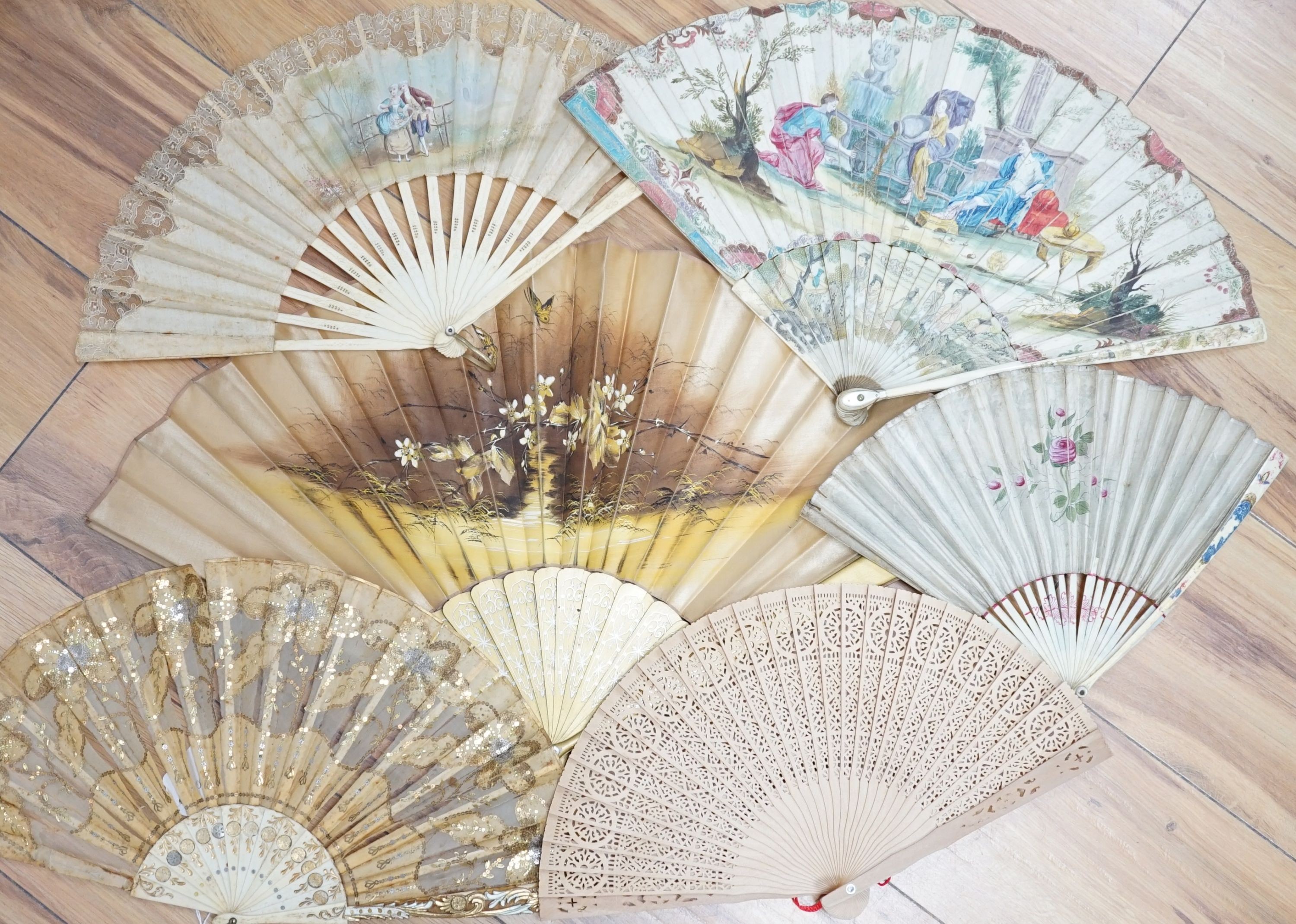 Five various fans, and an 18th century painted leaf fan with ivory chinoiserie decorated guards and sticks, 28 cms high (6)